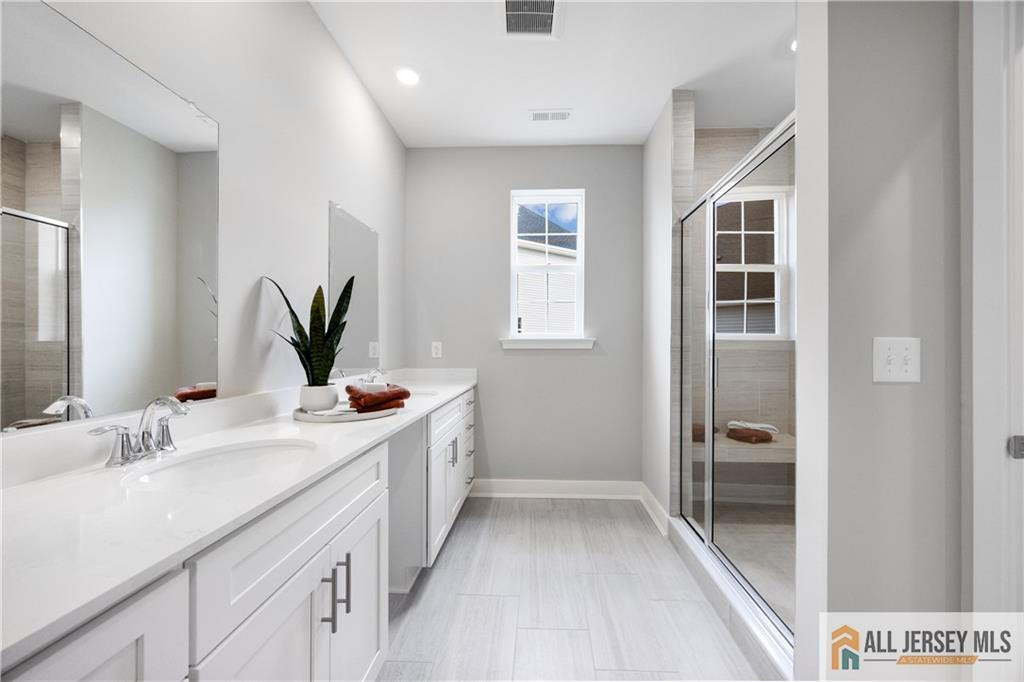 4 Prado Road Monroe Township, NJ 08831 - Photo 16 of 21 a bathroom with a double vanity sink and a mirror