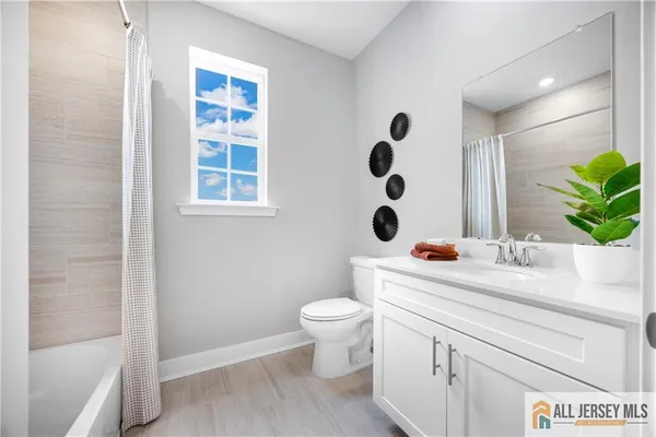 a bathroom with a sink a toilet and a shower
