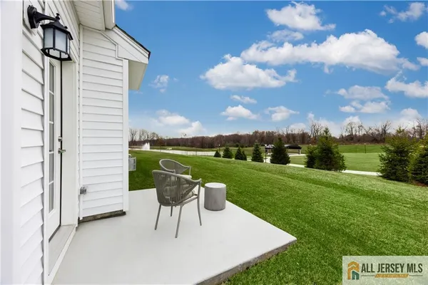 a view of a chairs and table in backyard of the house