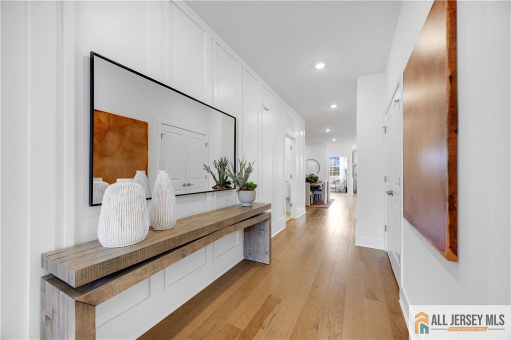 4 Prado Road Monroe Township, NJ 08831 - Photo 3 of 21 a hallway with view of living room with furniture and wooden floor