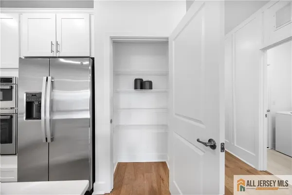 a view of walk in closet with empty racks