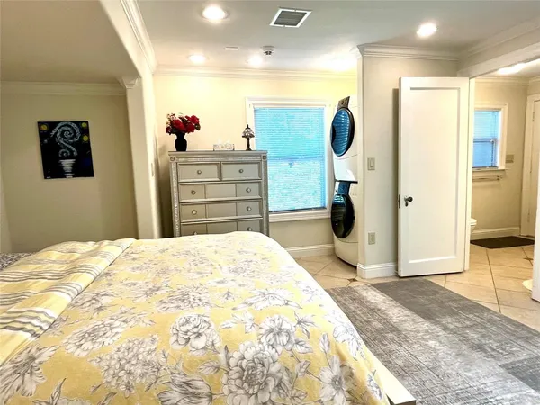 a bedroom with a bed and a large mirror