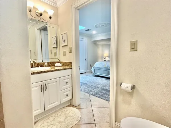 a bathroom with a granite countertop sink mirror and vanity