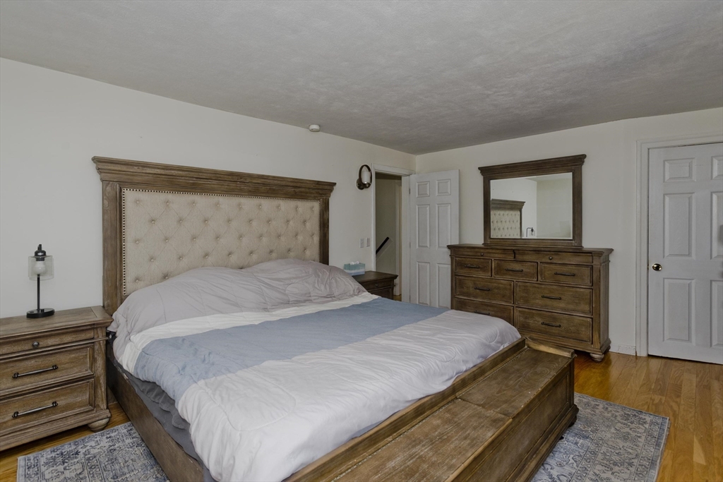 3 Fontaine Street Ludlow, MA 01056 - Photo 26 of 41 a bedroom with a bed and wooden floor