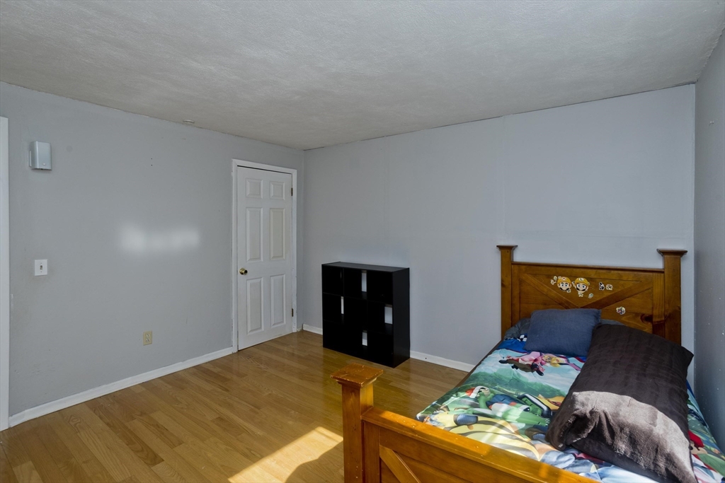 3 Fontaine Street Ludlow, MA 01056 - Photo 34 of 41 a bed room with a bed and a lamp