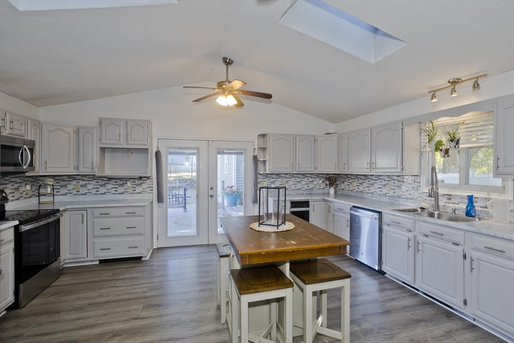 3 Fontaine Street Ludlow, MA 01056 - Photo 4 of 41 a kitchen with white cabinets stainless steel appliances and dining table