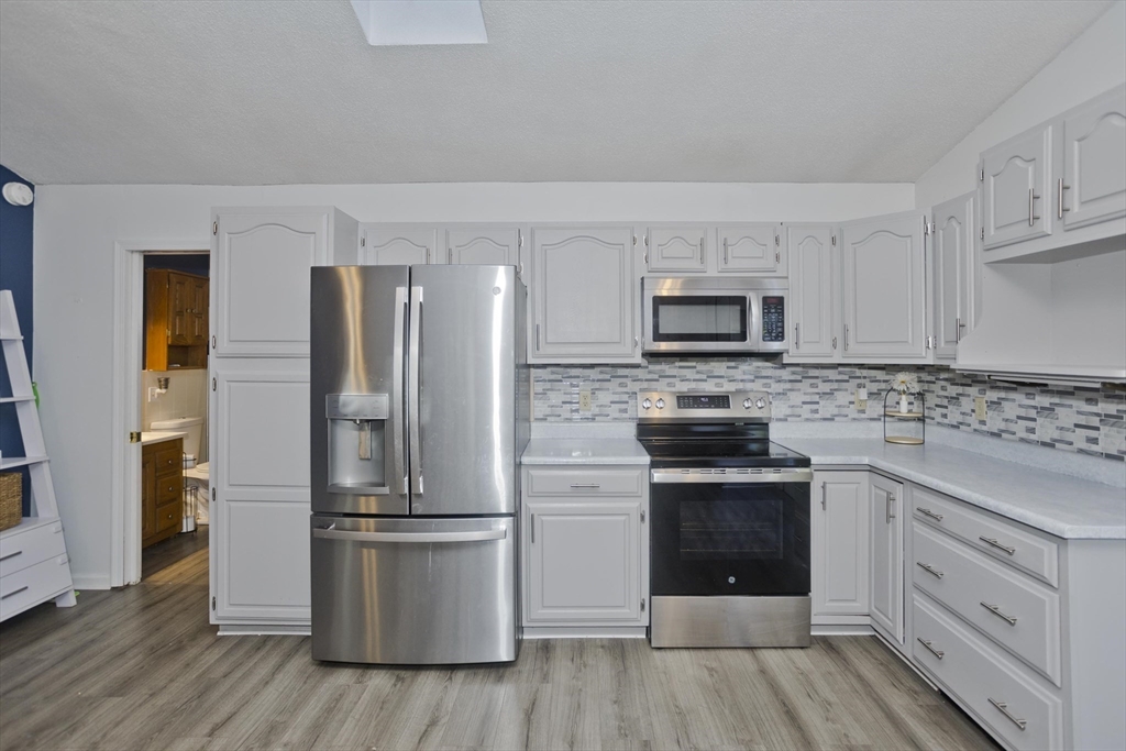 3 Fontaine Street Ludlow, MA 01056 - Photo 8 of 41 a kitchen with a refrigerator stove and sink