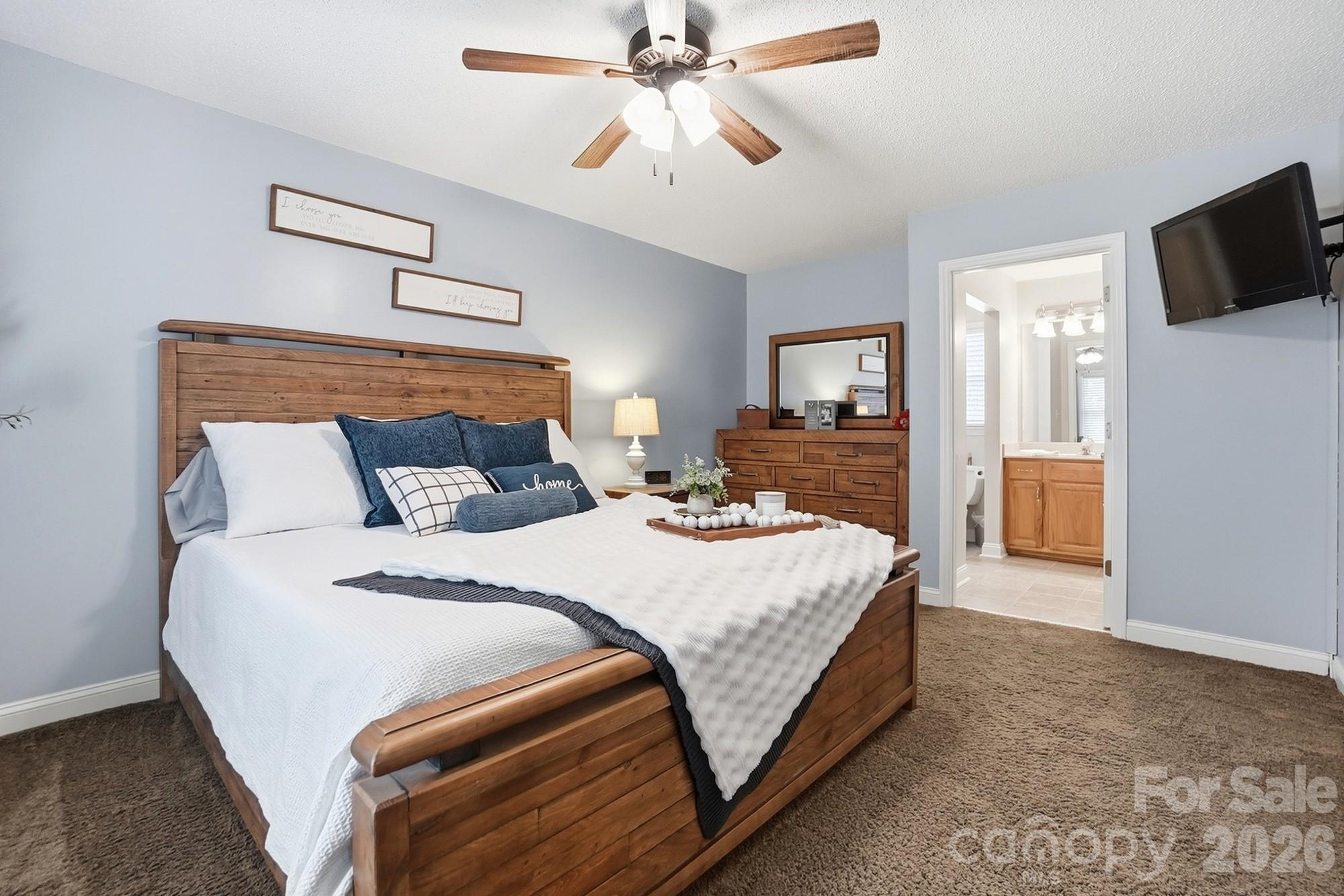 4017 Mullis Newsome Road Monroe, NC 28110 - Photo 23 of 38 a bedroom with bed and flat tv