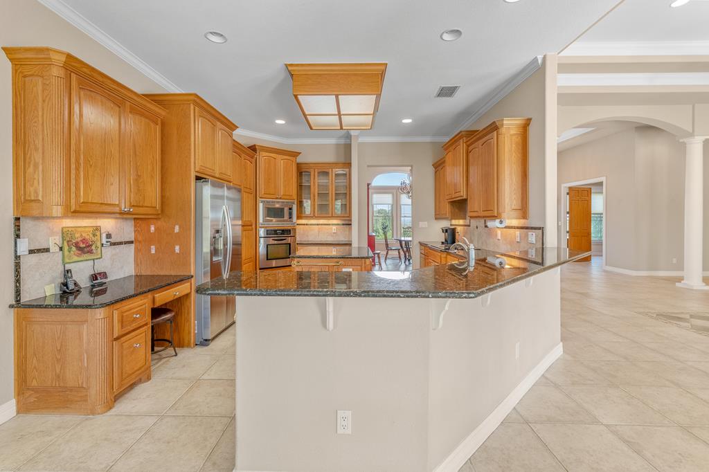1662 Landmark Kerrville, TX 78028 - Photo 11 of 30 a large kitchen with kitchen island a sink a counter top space a large window and stainless steel appliances
