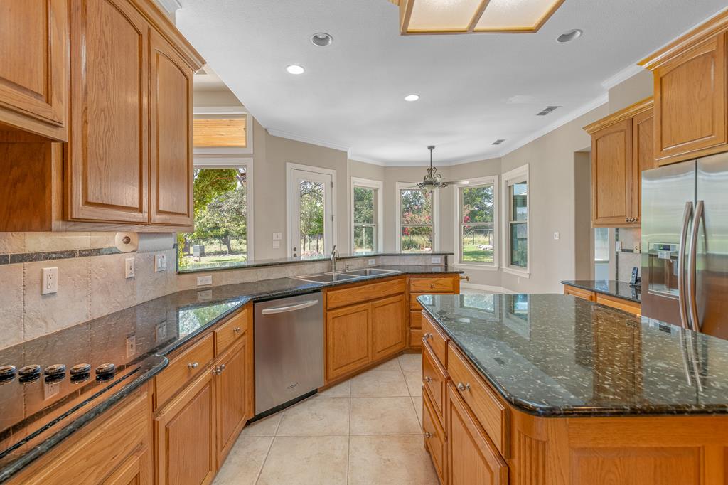 1662 Landmark Kerrville, TX 78028 - Photo 13 of 30 a kitchen with stainless steel appliances granite countertop a sink and a counter space
