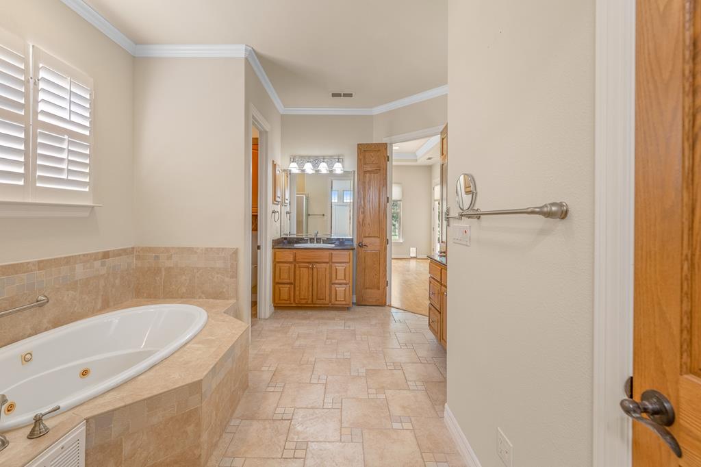1662 Landmark Kerrville, TX 78028 - Photo 18 of 30 a bathroom with a tub sink shower and a mirror