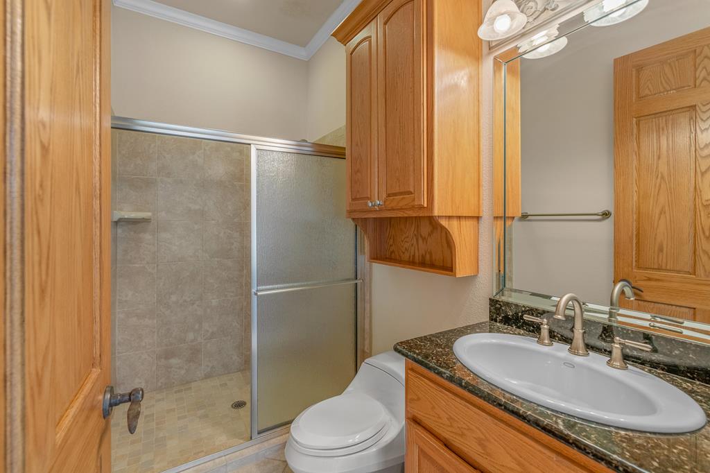 1662 Landmark Kerrville, TX 78028 - Photo 21 of 30 a bathroom with a granite countertop sink toilet and shower