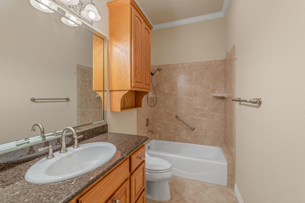1662 Landmark Kerrville, TX 78028 - Photo 23 of 30 a bathroom with a granite countertop sink toilet and shower
