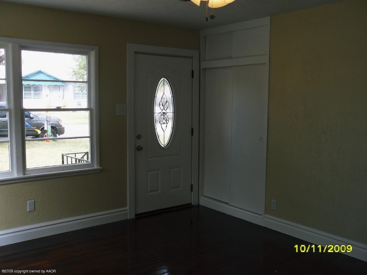 1709 Clarence Street Amarillo, TX 79110 - Photo 2 of 10 an empty room with windows and entrance