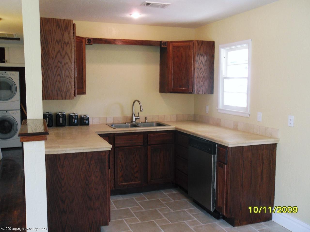 1709 Clarence Street Amarillo, TX 79110 - Photo 5 of 10 a kitchen with a sink cabinets and a stove top oven