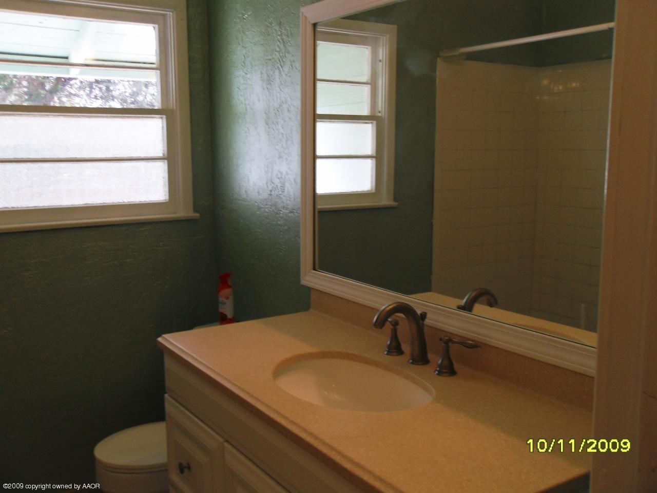 1709 Clarence Street Amarillo, TX 79110 - Photo 7 of 10 a bathroom with a sink toilet and window