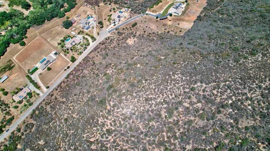 23050 Tombill Road Ramona, CA 92065 - Photo 9 of 11 an aerial view of a house with a yard and large trees