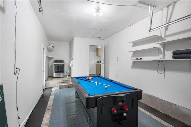 a room with pool table and a chandelier