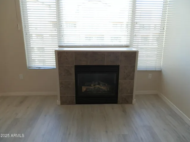 a living room with a fireplace and windows
