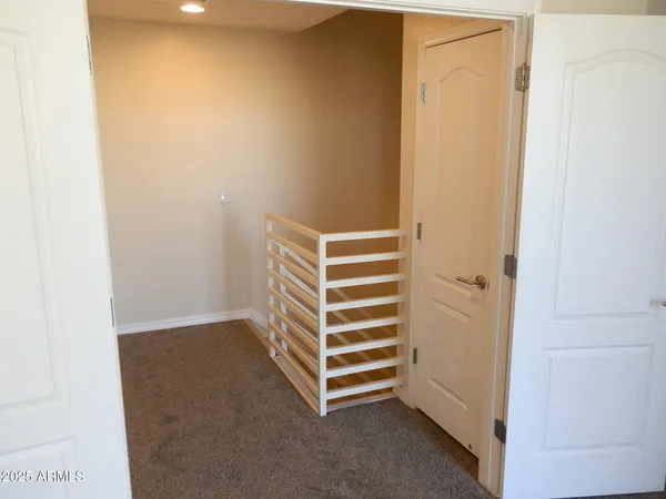 a view of room with stairs and a bathroom