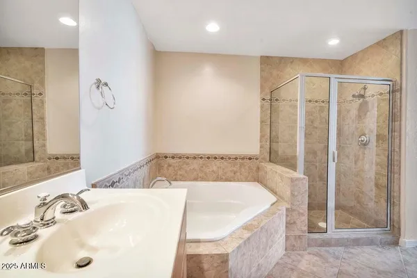 a bathroom with a tub a sink and a shower