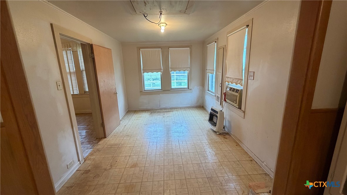 701 East 10th Street Cameron, TX 76520 - Photo 12 of 19 a view of hallway with windows and chandelier