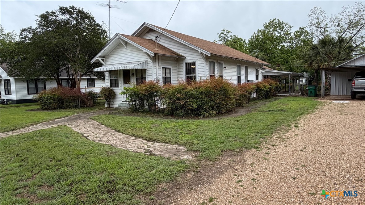 701 East 10th Street Cameron, TX 76520 - Photo 2 of 19 a front view of a house with a yard and garage