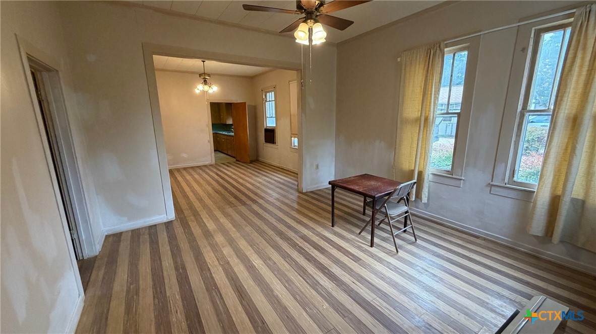 701 East 10th Street Cameron, TX 76520 - Photo 3 of 19 a living room with furniture and a wooden floor
