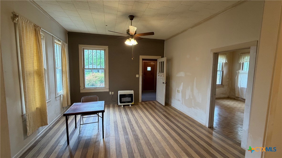 701 East 10th Street Cameron, TX 76520 - Photo 4 of 19 a view of a livingroom with furniture and wooden floor