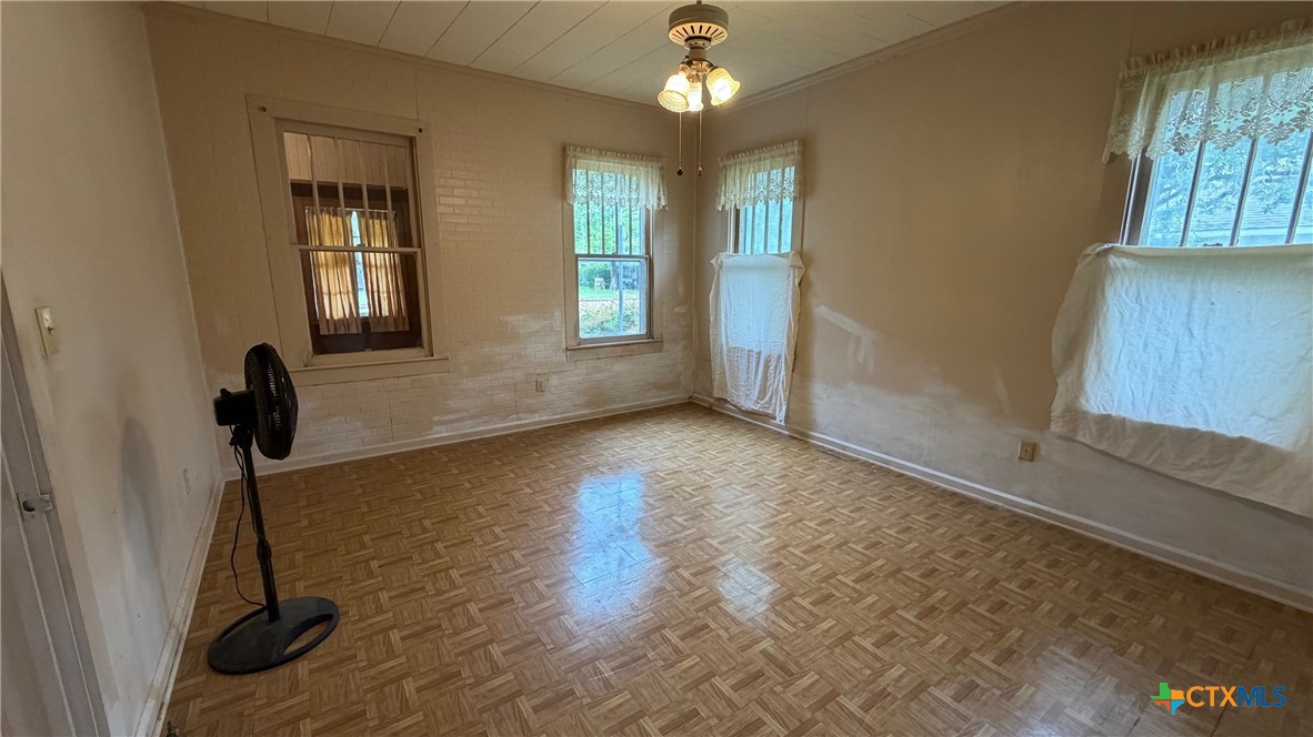 701 East 10th Street Cameron, TX 76520 - Photo 10 of 19 a view of empty room with windows