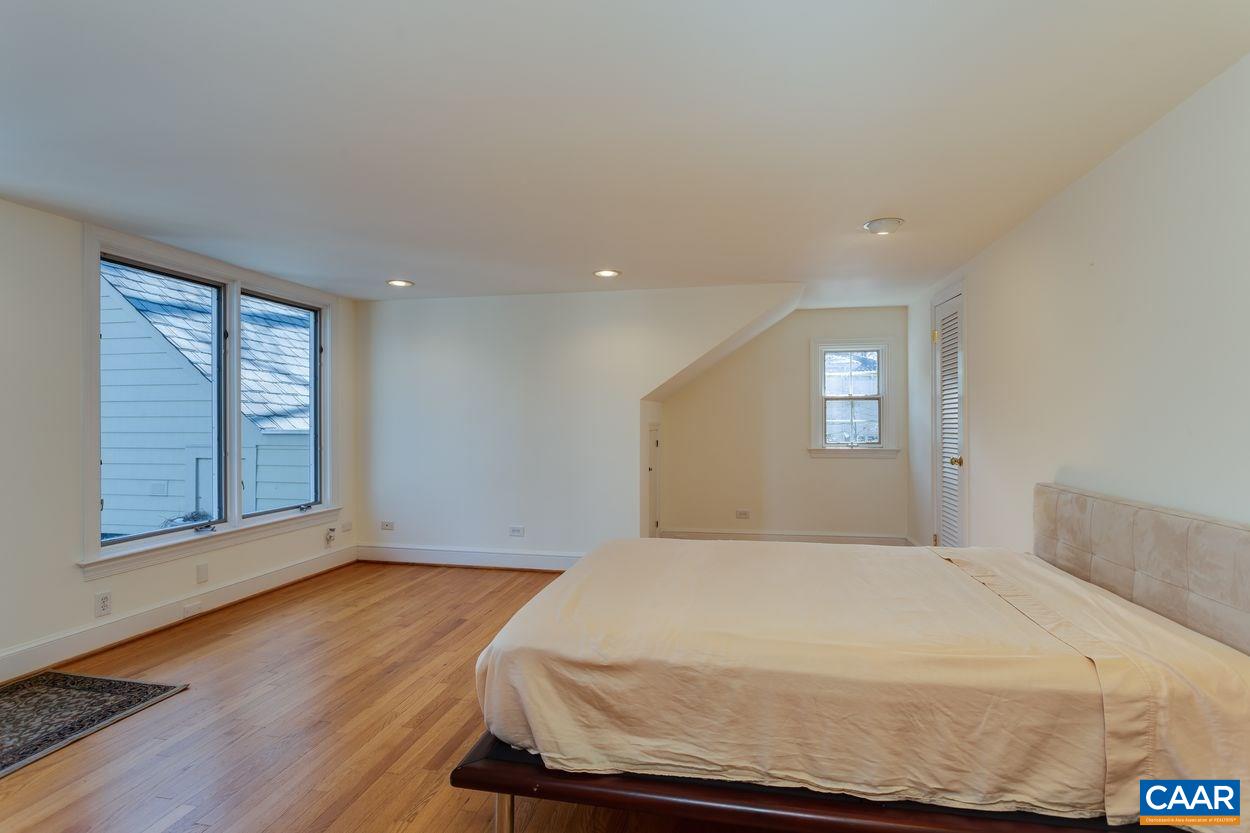 1861 Field Road Charlottesville, VA 22903 - Photo 30 of 49 a bed sitting in a spacious bedroom next to a window