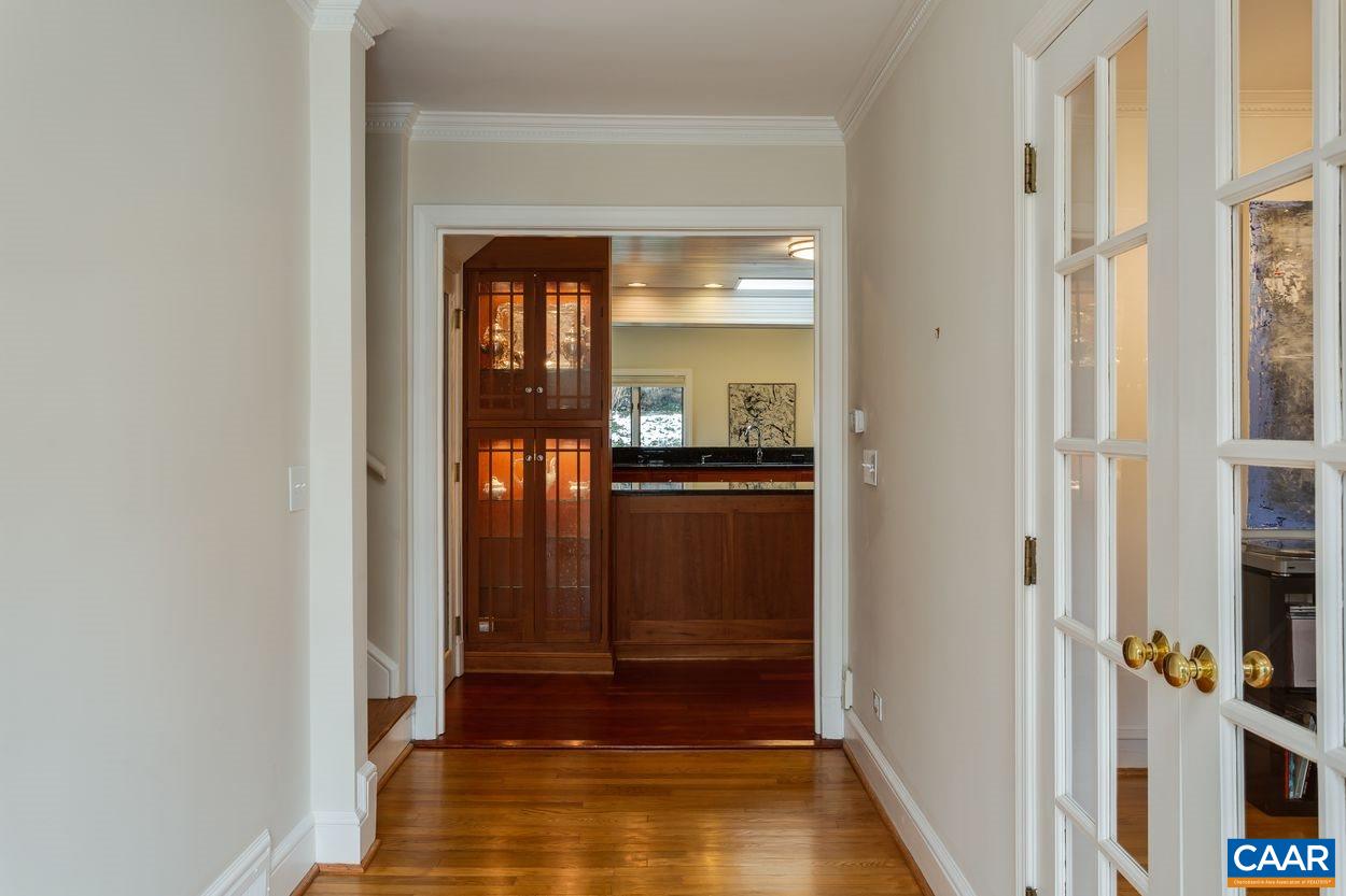 1861 Field Road Charlottesville, VA 22903 - Photo 5 of 49 a view of a hallway with wooden floor and a living room