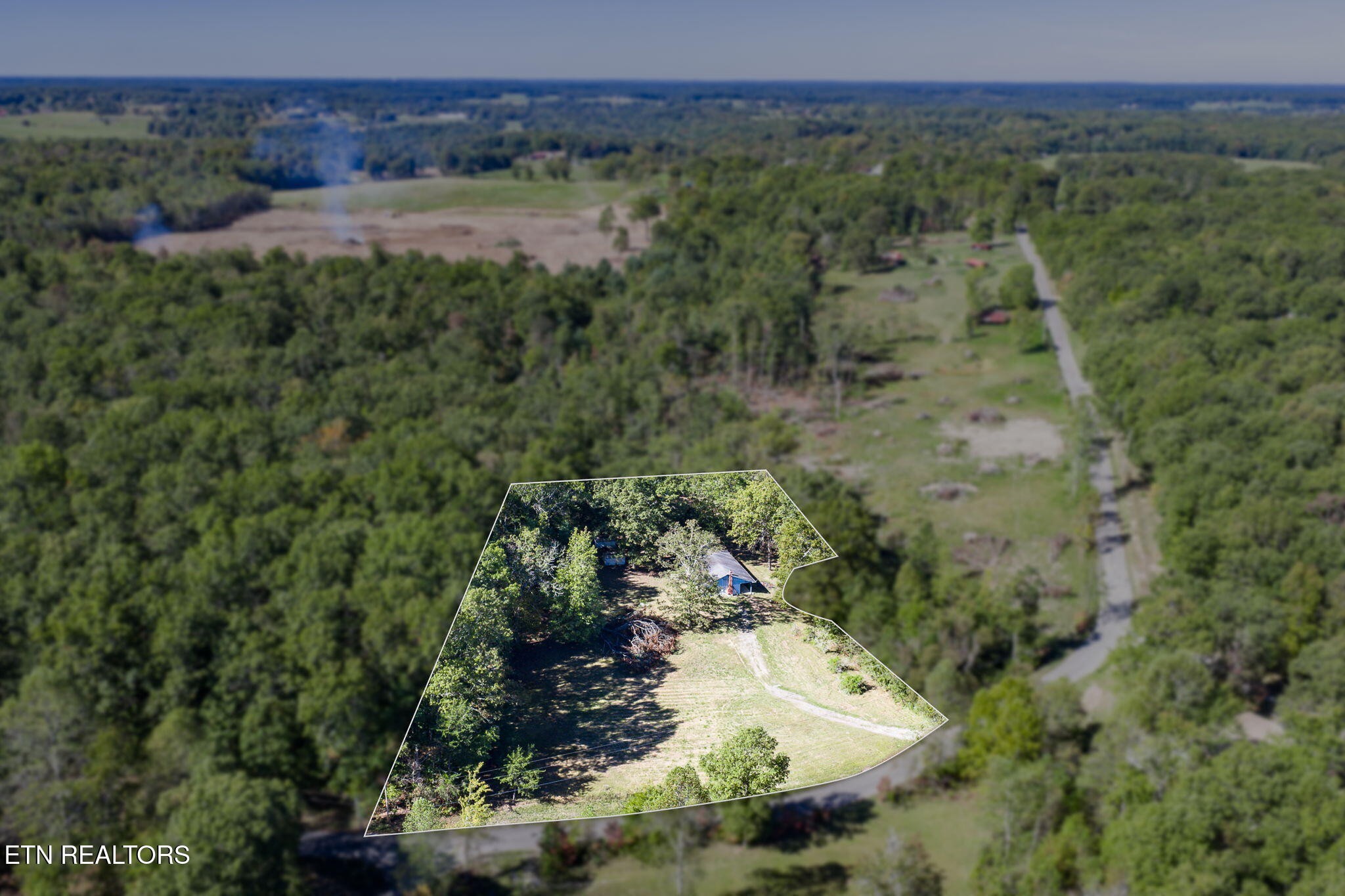 1602 Hollis Poore Road Jamestown, TN 38556 - Photo 2 of 25 a view of a lake with a mountain and trees all around