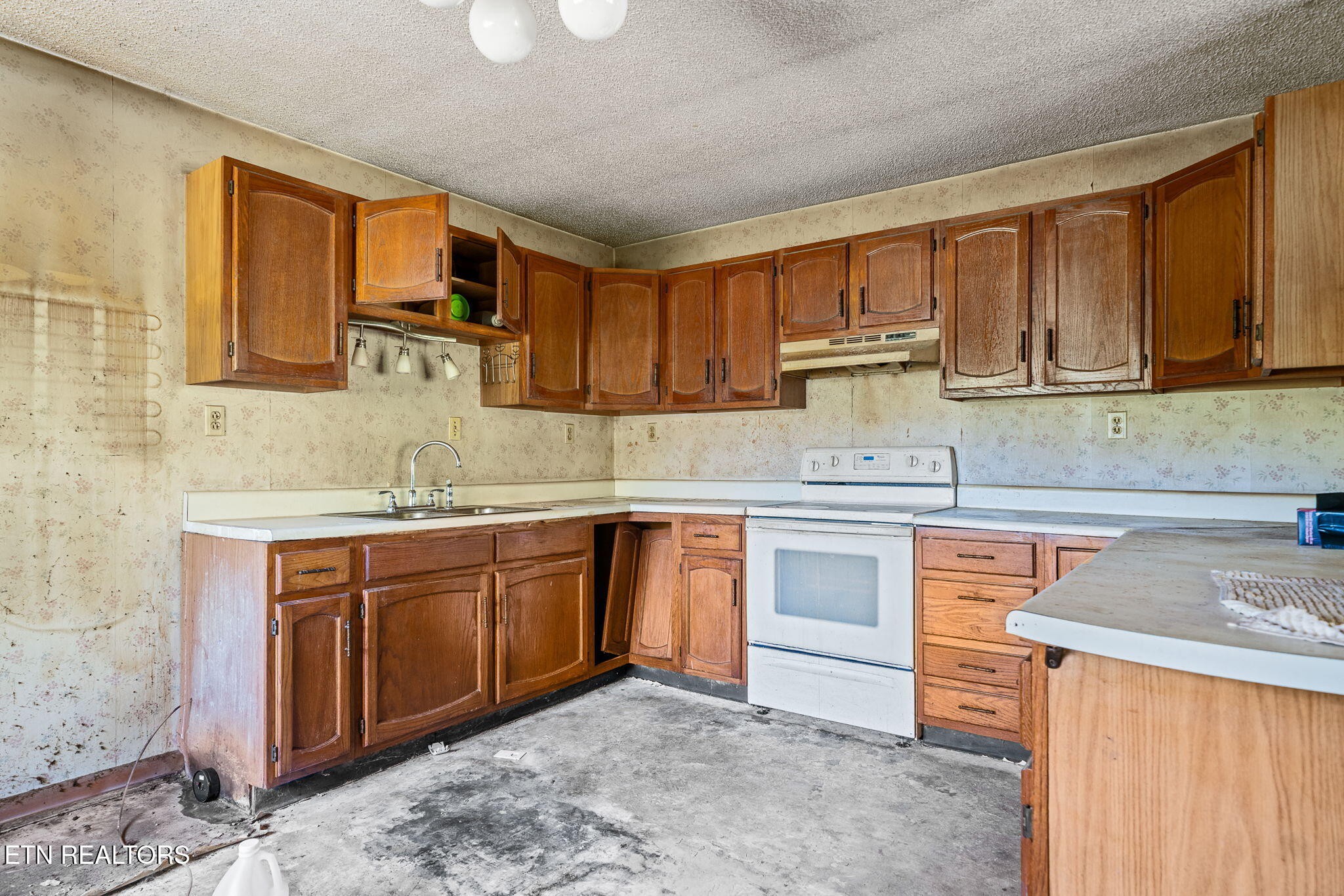 1602 Hollis Poore Road Jamestown, TN 38556 - Photo 7 of 25 a kitchen with stainless steel appliances granite countertop a sink stove and cabinets