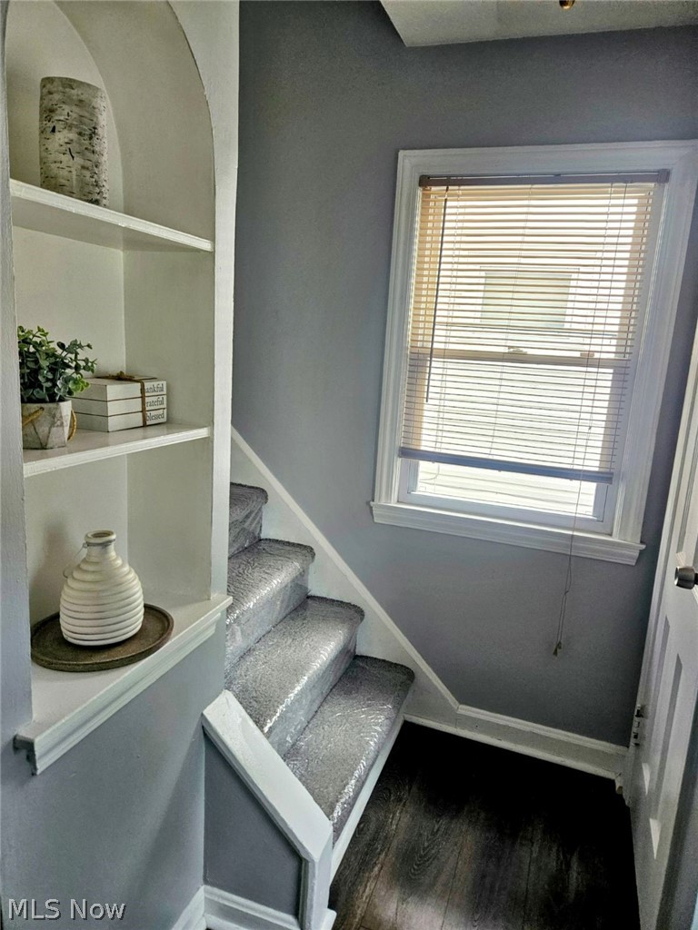 3741 Grosvenor Road Cleveland, OH 44118 - Photo 7 of 32 Staircase with dark hardwood / wood-style flooring and plenty of natural light