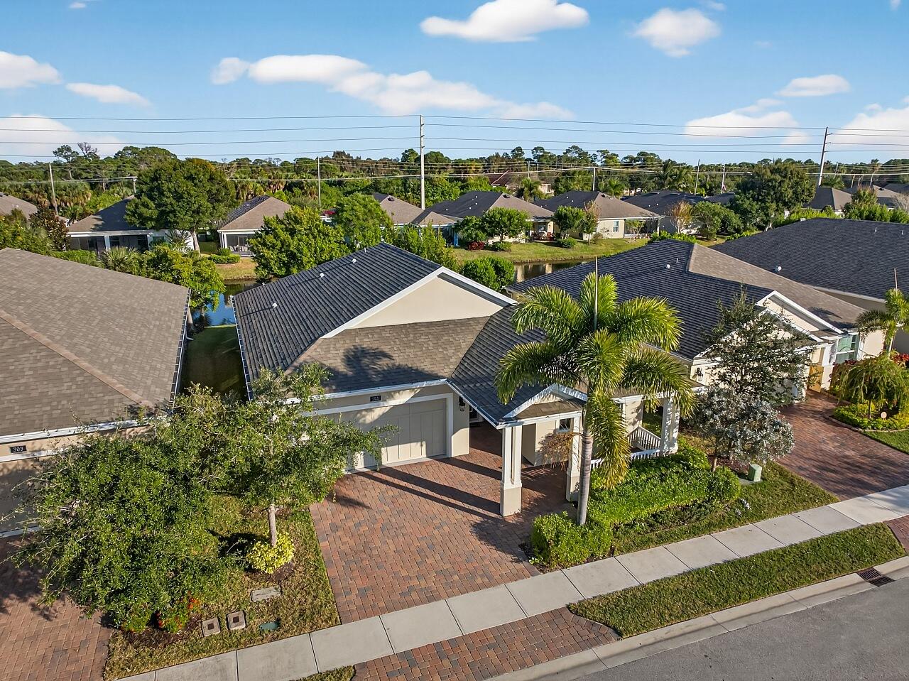 an aerial view of residential houses with outdoor space and street view