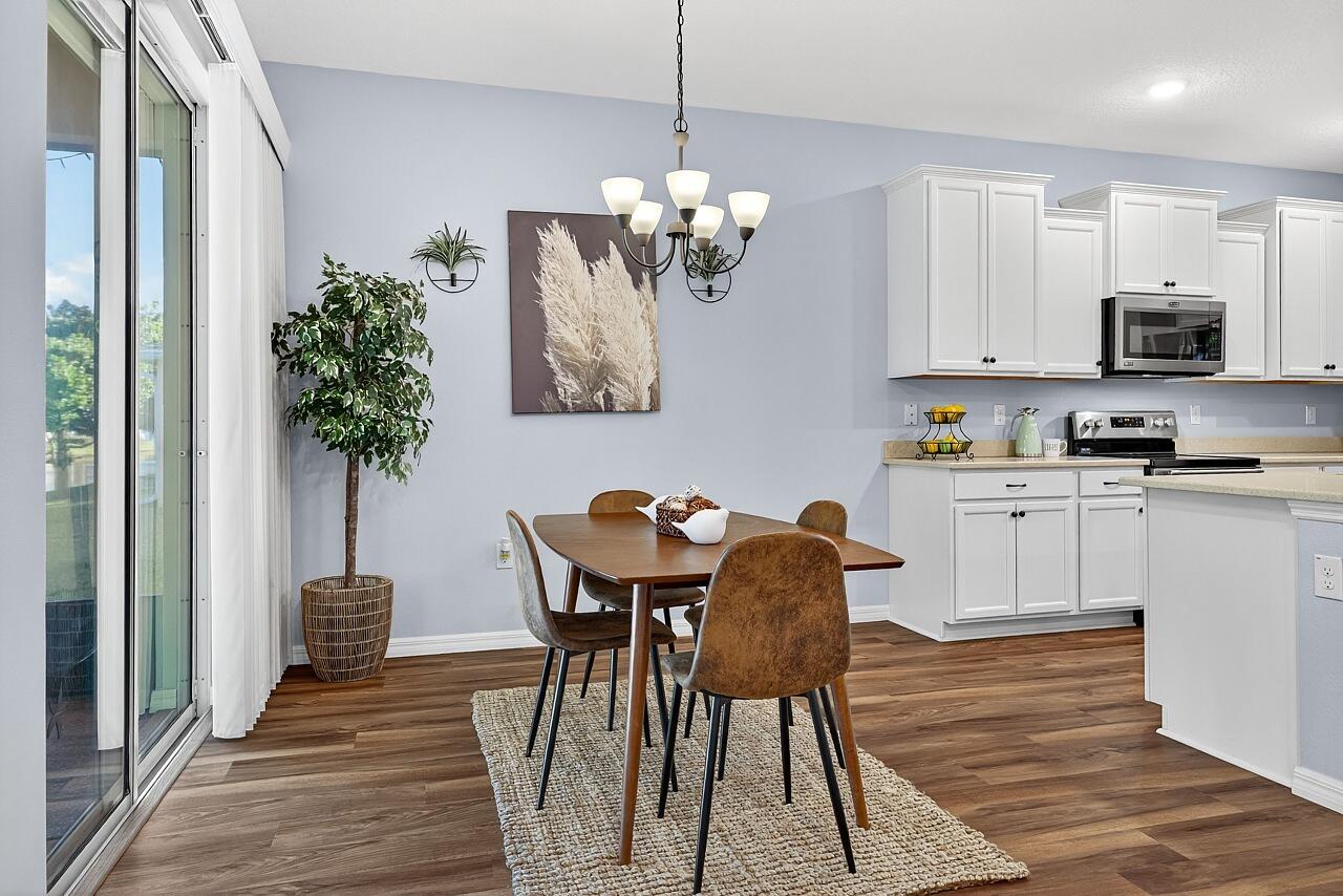 313 Sandcrest Circle Sebastian, FL 32958 - Photo 17 of 42 a view of a dining room with furniture and a chandelier