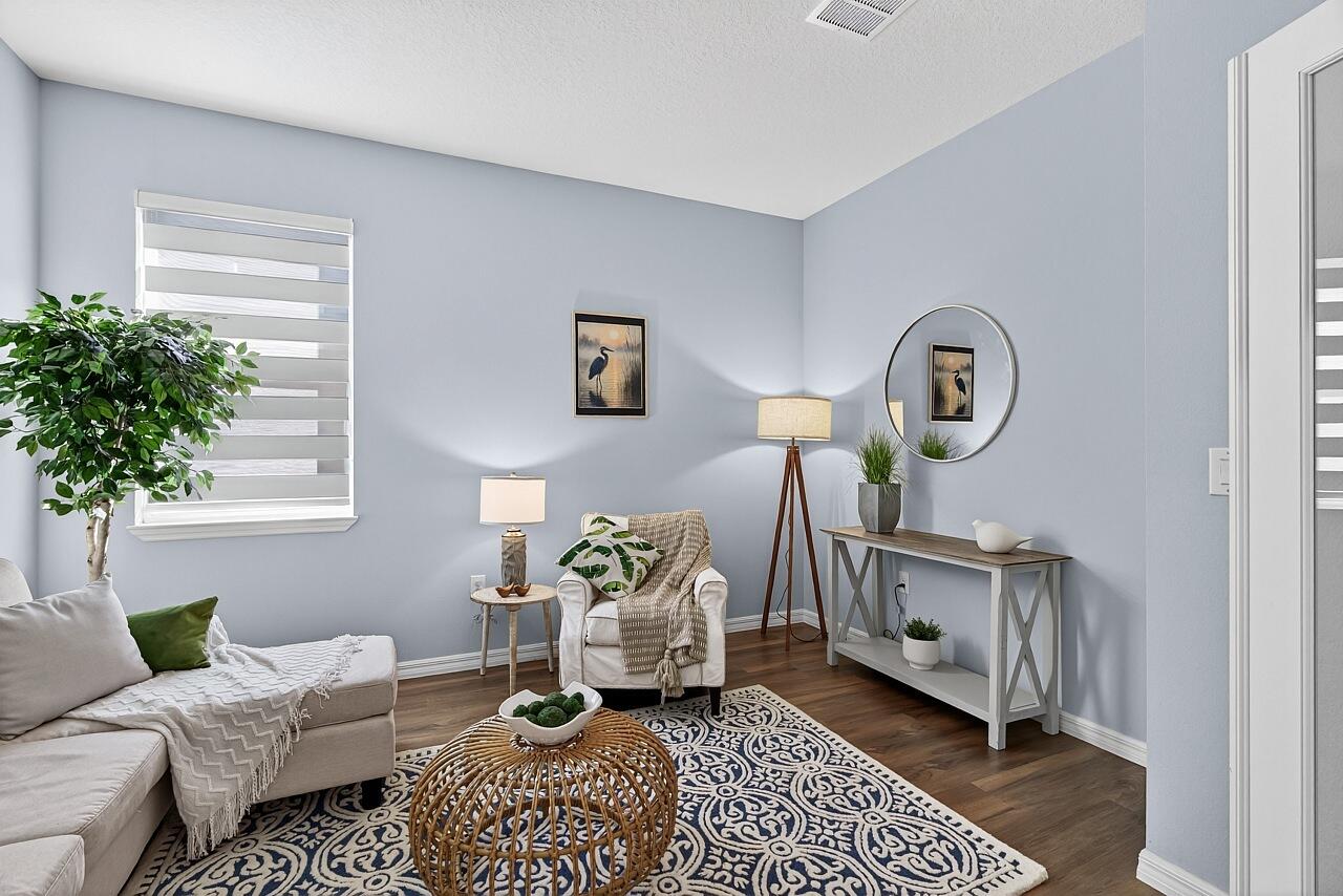 313 Sandcrest Circle Sebastian, FL 32958 - Photo 19 of 42 a living room with furniture a window and a potted plant