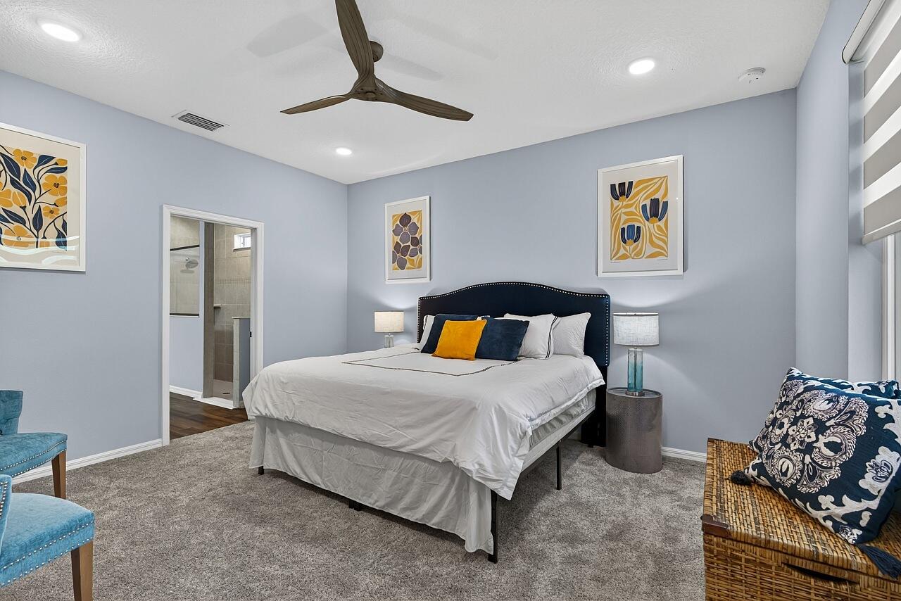 313 Sandcrest Circle Sebastian, FL 32958 - Photo 20 of 42 a bedroom with a bed and a chandelier