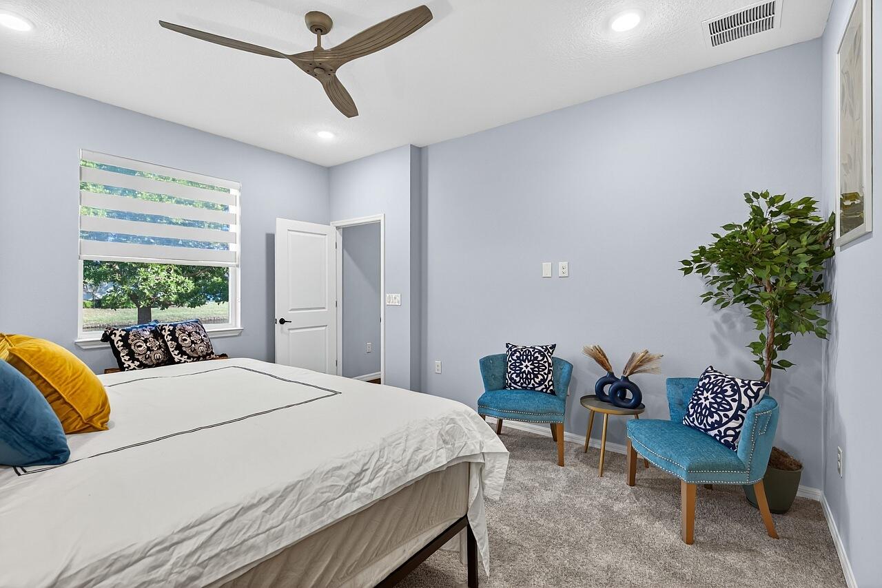 313 Sandcrest Circle Sebastian, FL 32958 - Photo 23 of 42 a bedroom with a bed table and a chair