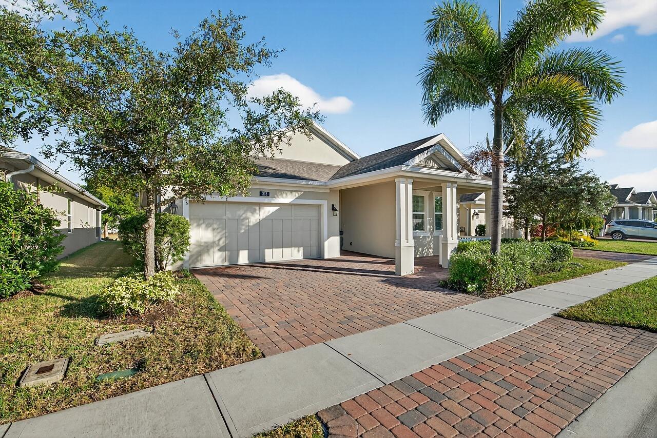 313 Sandcrest Circle Sebastian, FL 32958 - Photo 4 of 42 front view of a house with a yard and potted plants