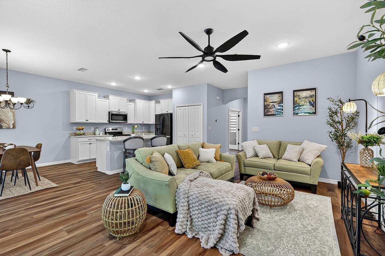 313 Sandcrest Circle Sebastian, FL 32958 - Photo 10 of 42 a living room with furniture kitchen view and a chandelier