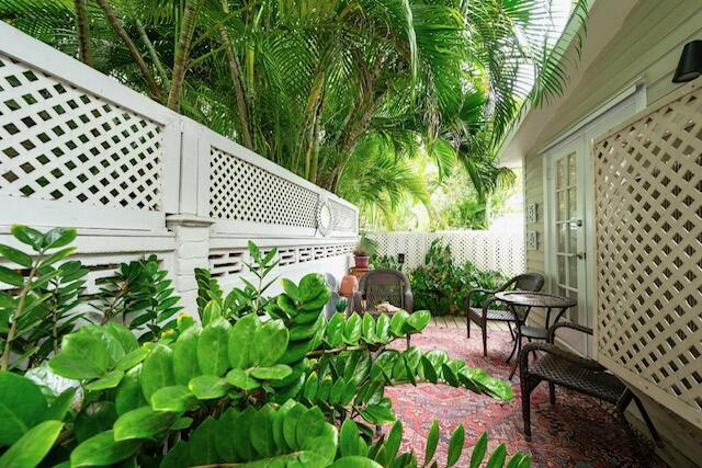 1218 Packer Street, Unit REAR Key West, FL 33040 - Photo 21 of 22 a patio with table and chairs and potted plants