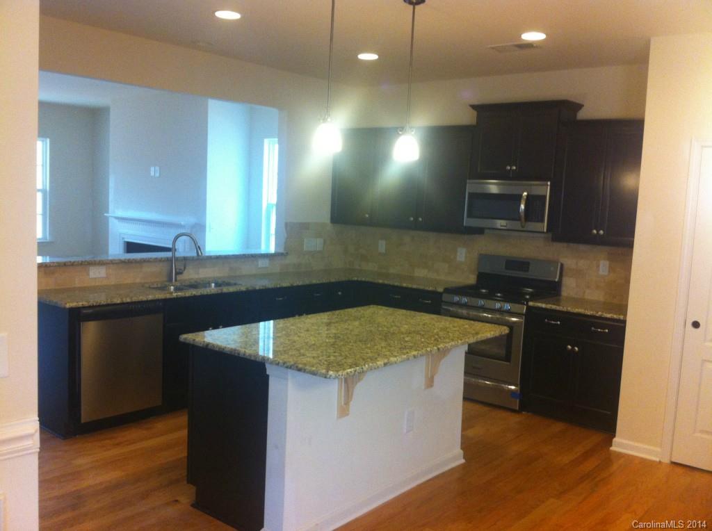 4266 Perth Road, Unit 311 Indian Land, SC 29707 - Photo 3 of 12 a kitchen with stainless steel appliances granite countertop a sink and a stove
