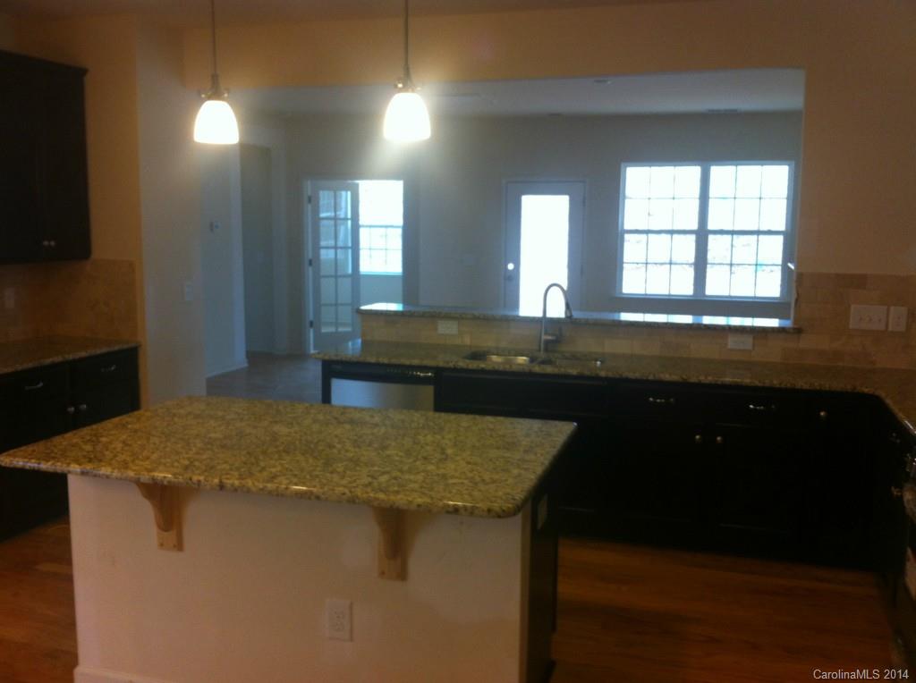 4266 Perth Road, Unit 311 Indian Land, SC 29707 - Photo 4 of 12 a kitchen with a sink and wooden floor