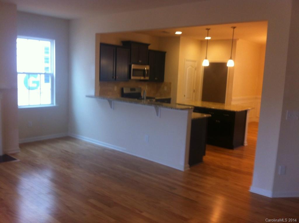 4266 Perth Road, Unit 311 Indian Land, SC 29707 - Photo 5 of 12 a view of a kitchen with wooden floor and a large window