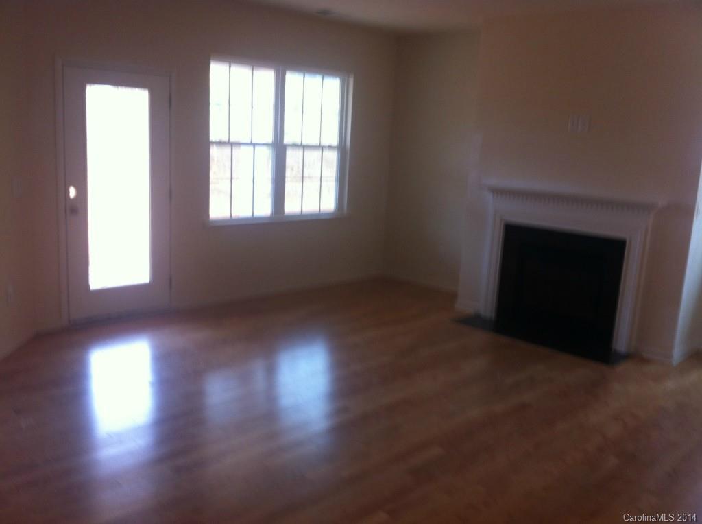 4266 Perth Road, Unit 311 Indian Land, SC 29707 - Photo 6 of 12 an empty room with wooden floor and windows