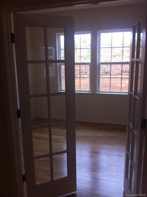 4266 Perth Road, Unit 311 Indian Land, SC 29707 - Photo 7 of 12 a view of an empty room with wooden floor and a window