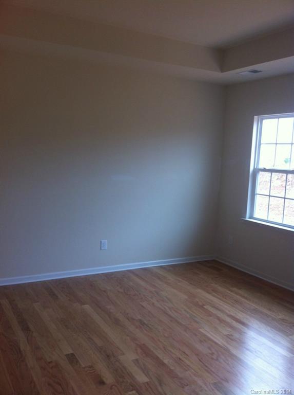 4266 Perth Road, Unit 311 Indian Land, SC 29707 - Photo 8 of 12 an empty room with wooden floor and windows