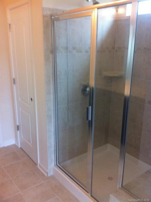 4266 Perth Road, Unit 311 Indian Land, SC 29707 - Photo 9 of 12 a bathroom with a glass shower door